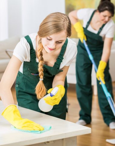 Group of friends as a professional cleaners tiding up big apartment